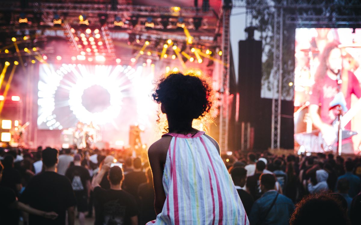Vibrant outdoor music festival in Casablanca, Morocco with a lively crowd and colorful stage lights.