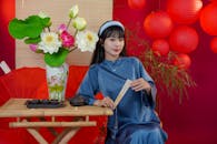 Elegant Asian Woman with Tea Set and Lanterns