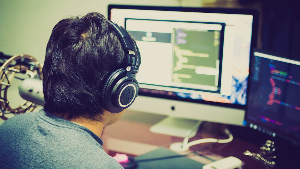 Free Selective Focus Photography of Man Facing Computer Stock Photo