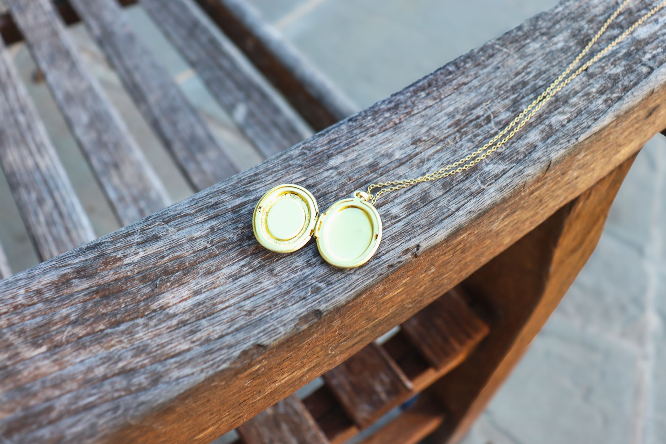 Elegant Open Locket on Rustic Wooden Bench · Free Stock Photo