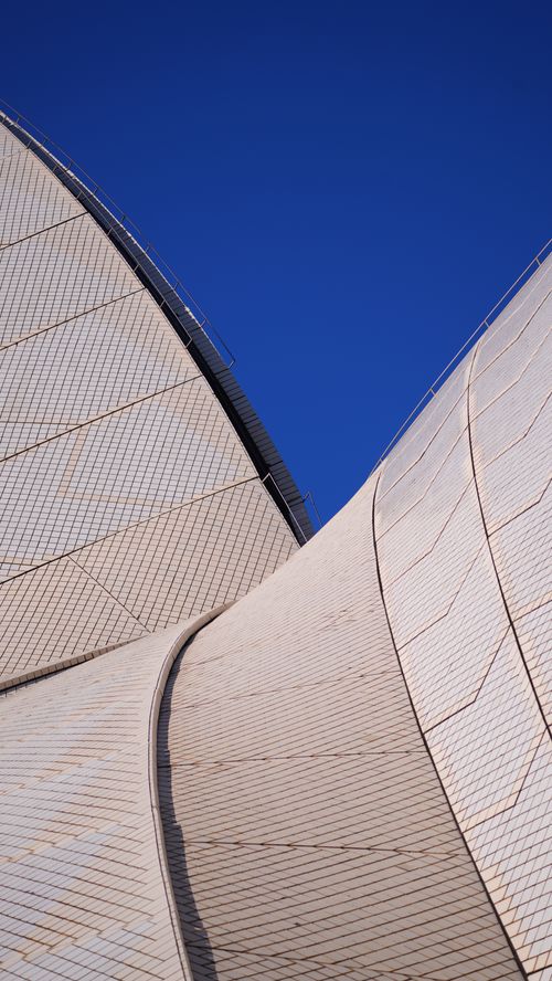 Free Close-up of Sydney Opera House sails against a vibrant blue sky, showcasing iconic modern architecture. Stock Photo
