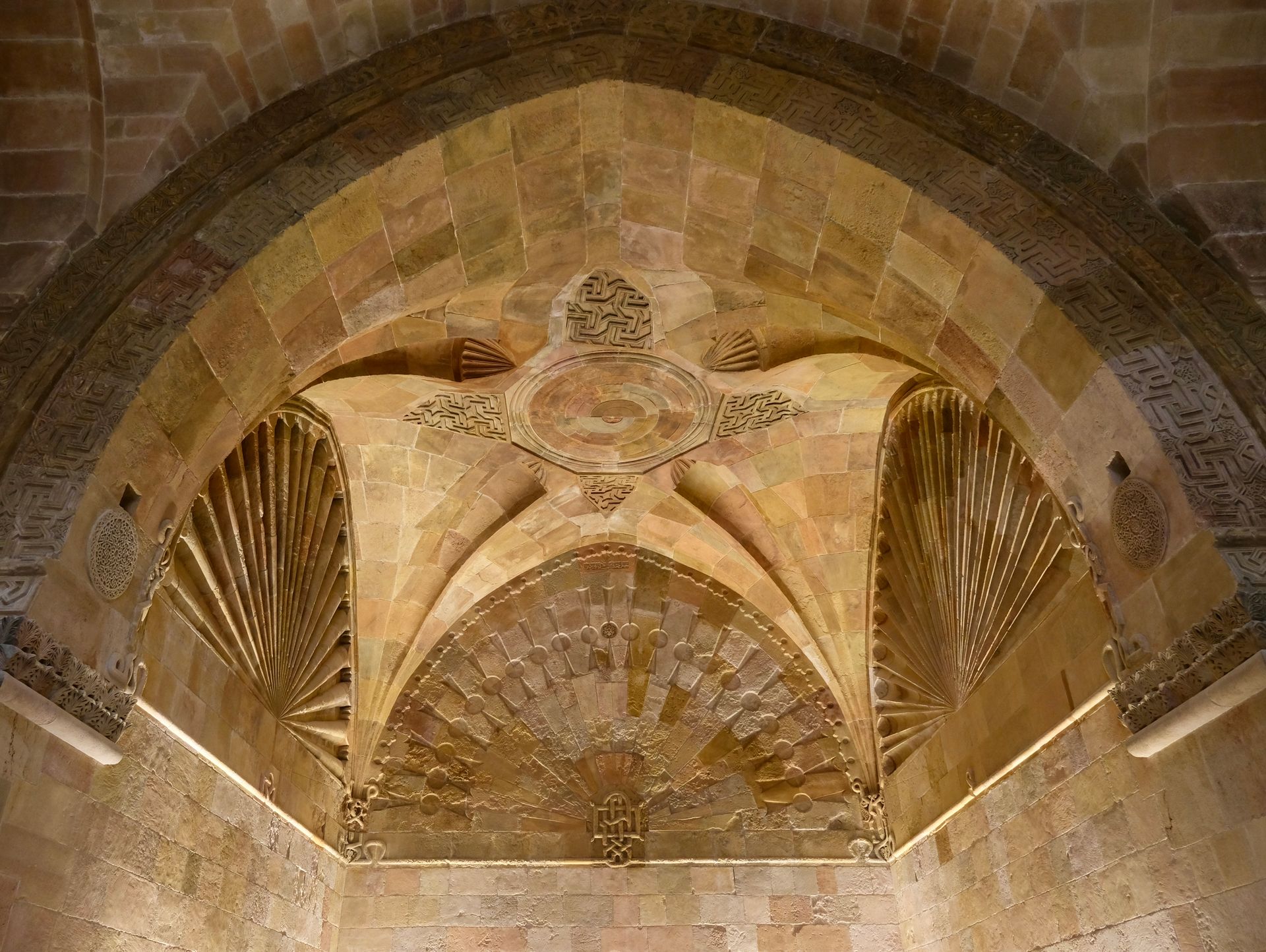 Detailed stone ceiling with intricate patterns in historical architecture.