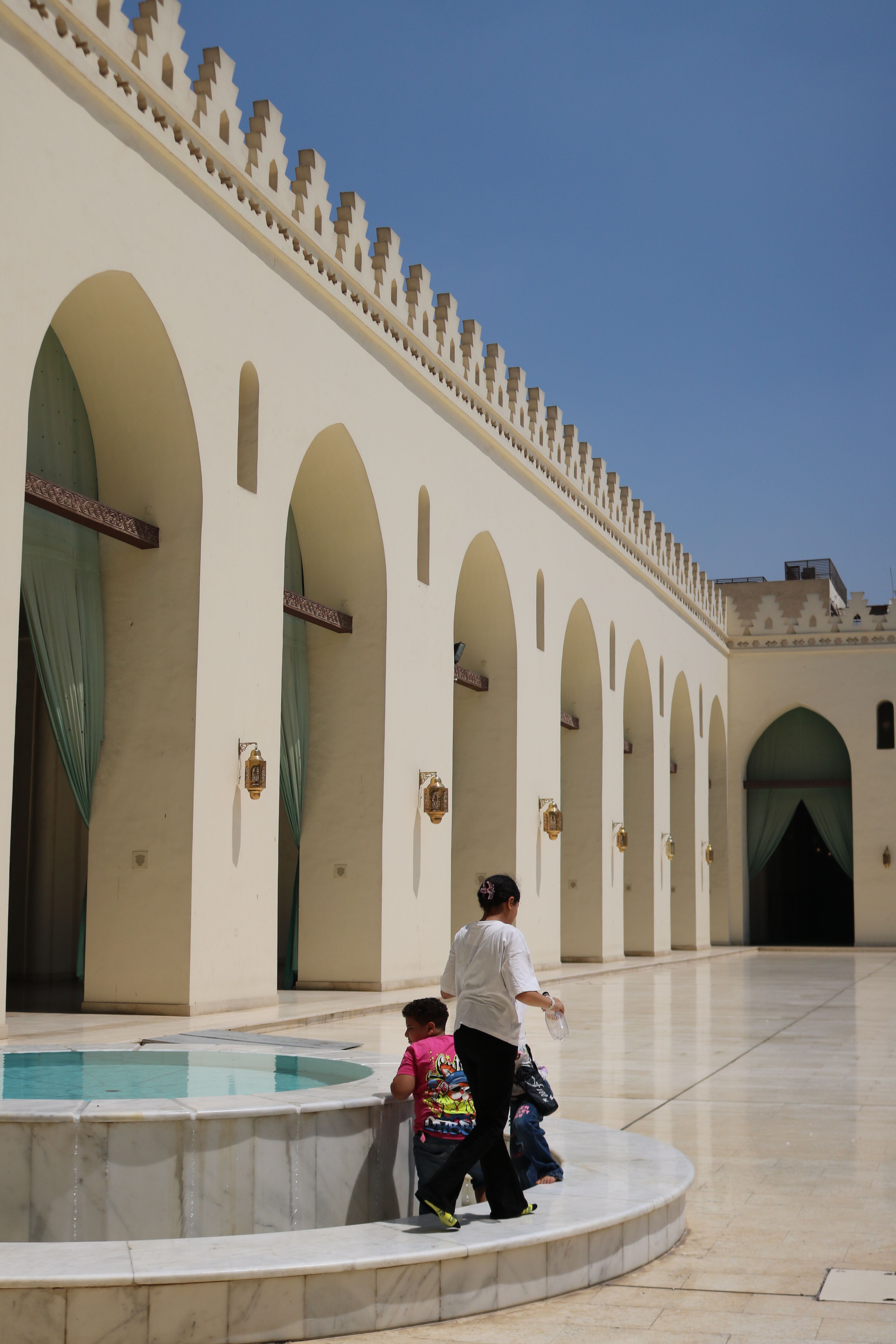 Explore the serene courtyard and arches of Al-Hakim Mosque in historic Cairo, Egypt.