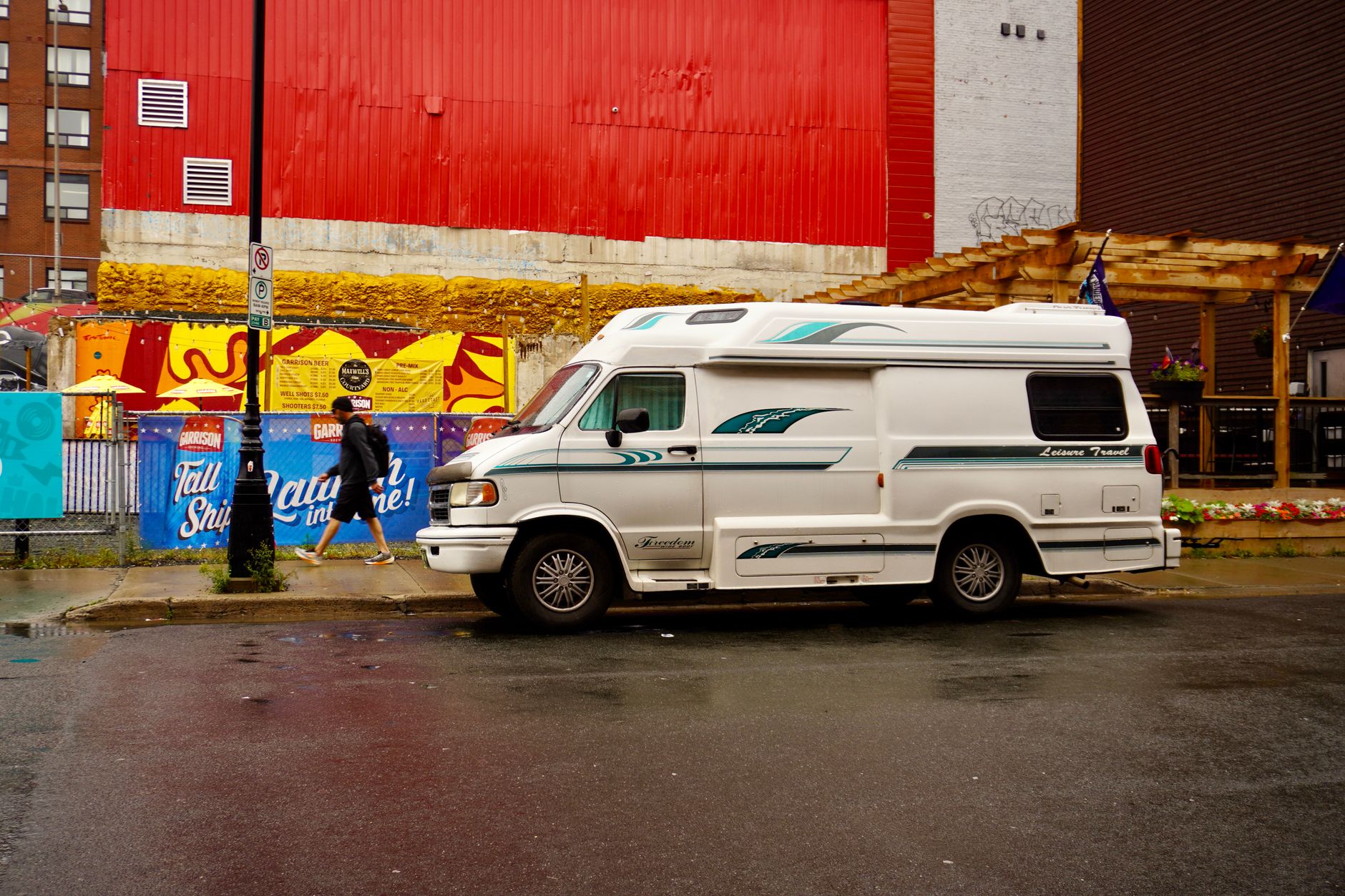 White camper van parked on a wet rainy street