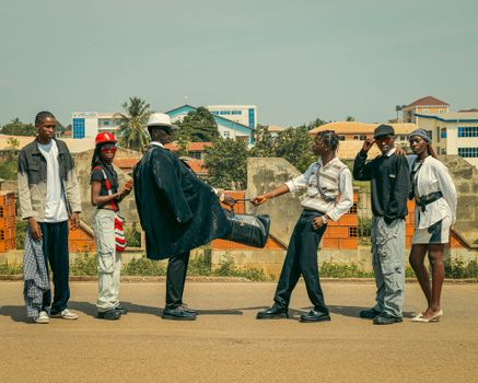 Group of young adults showcasing trendy fashion styles on an urban street.