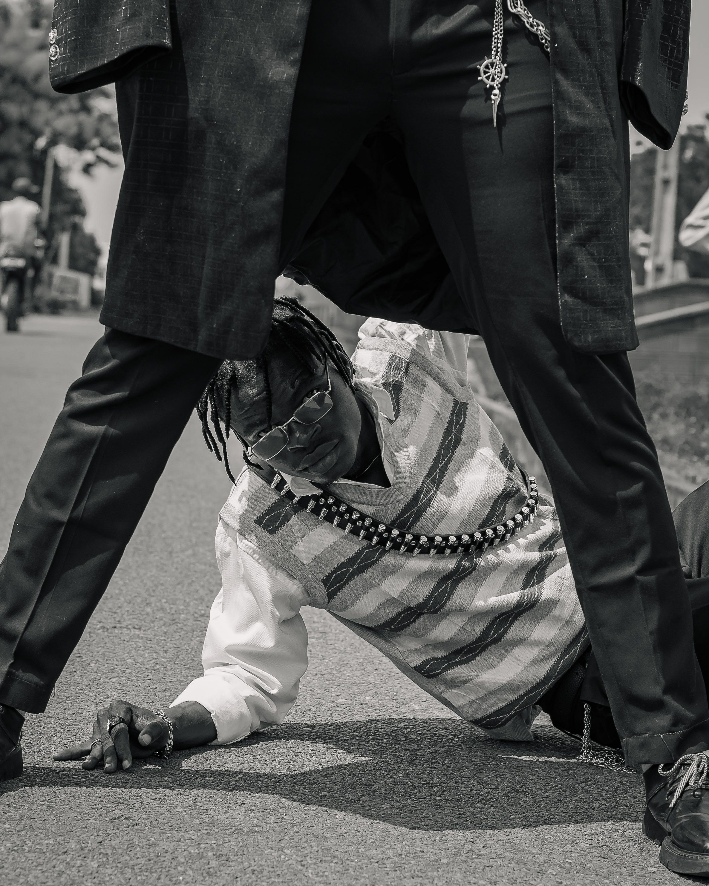 Dynamic black and white photo showcasing urban and creative street fashion in an outdoor setting.