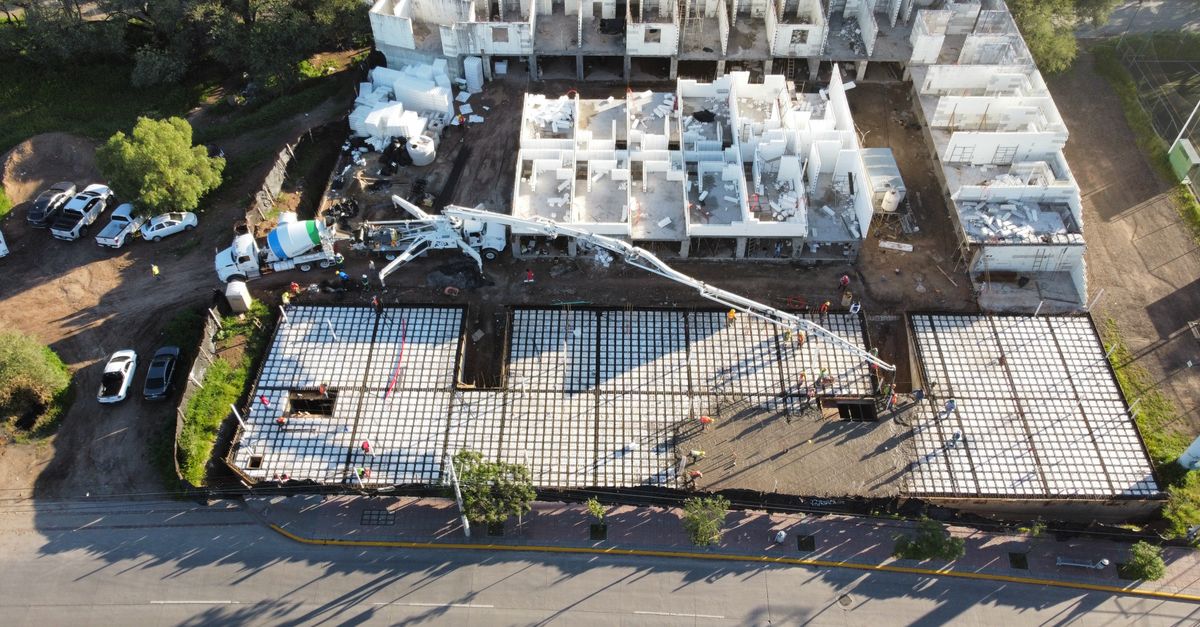 Aerial view of a construction site with foundation and building structures in progress in León, Mexico.