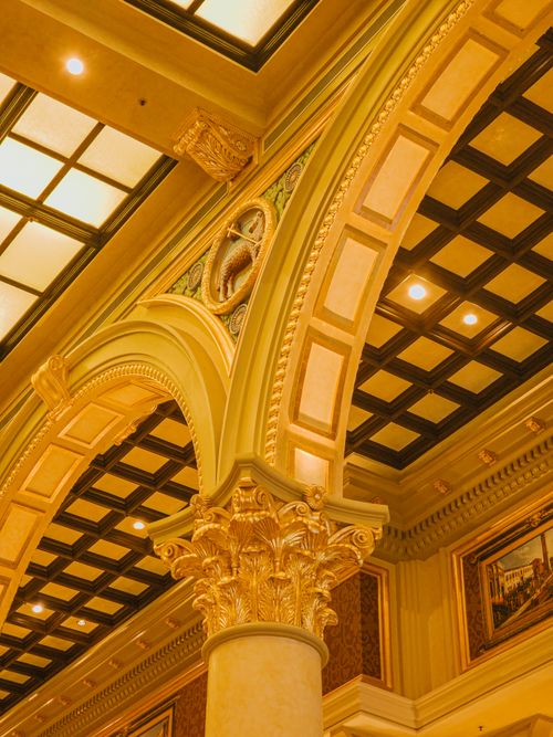 Free Ornate architectural details inside a luxury building in Macao, featuring golden arches and intricate designs. Stock Photo