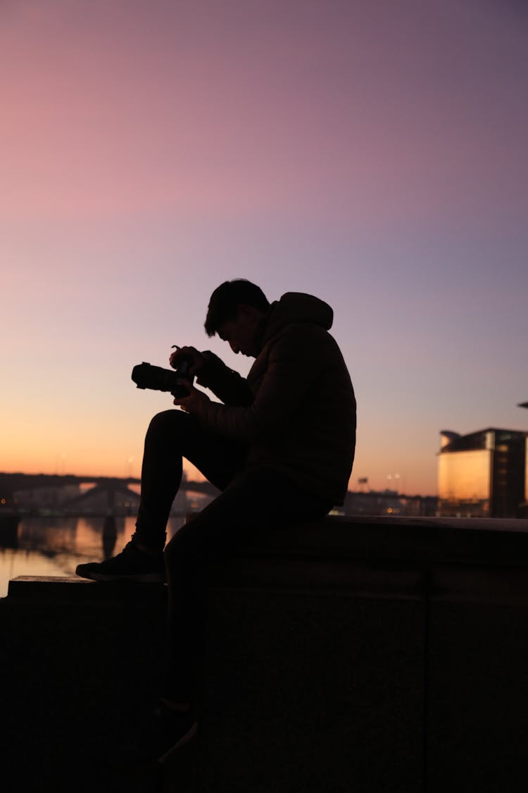 Silhouette Of A Man Holding A Camera