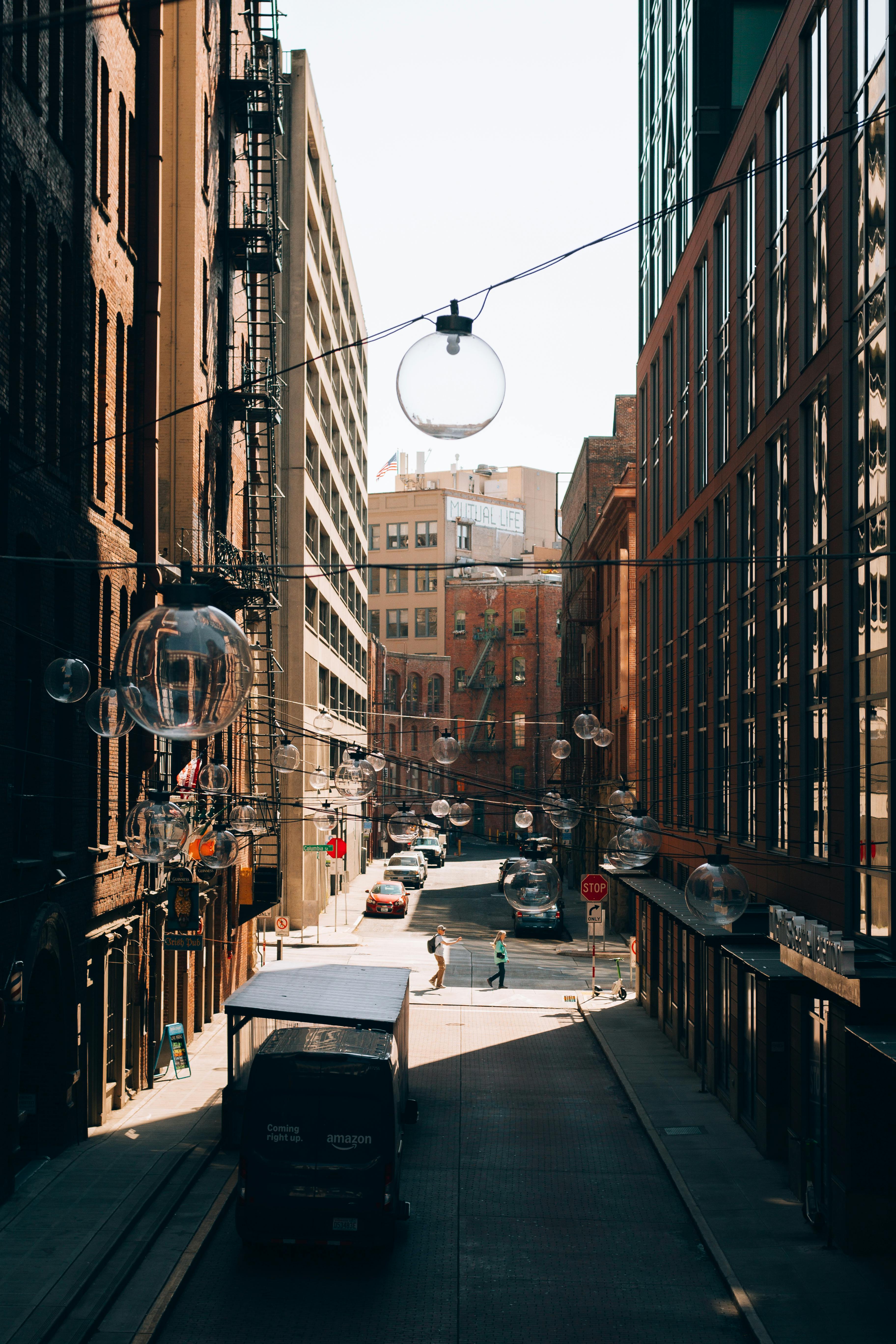 Charming Seattle street scene with glass orbs and brick buildings, evoking a warm city vibe.
