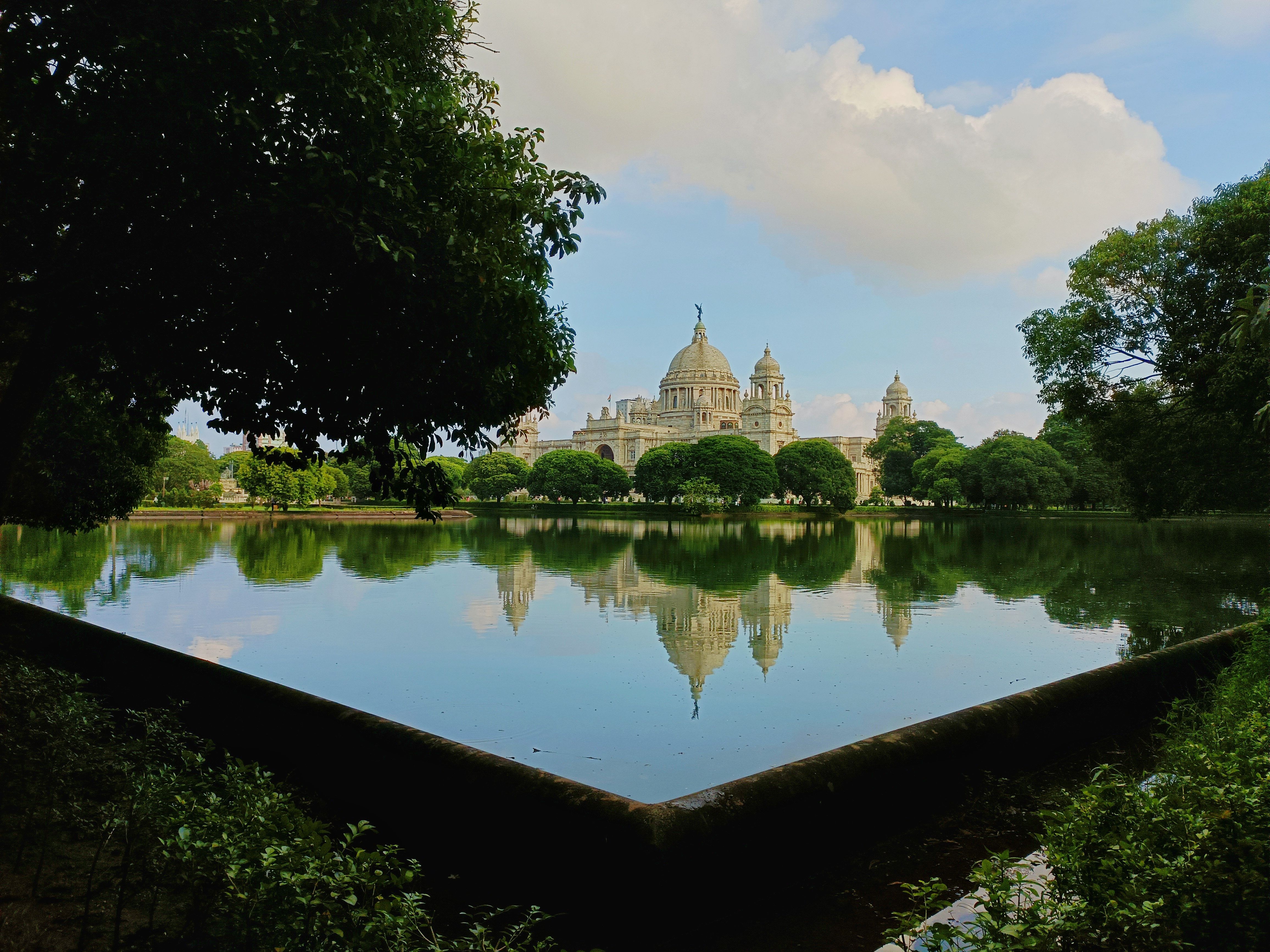 Captivating view of Victoria Memorial reflecting in garden pond, Kolkata.