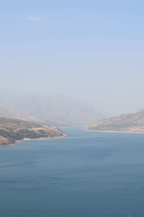Free Breathtaking aerial view of a tranquil reservoir surrounded by mountains in Uzbekistan. Stock Photo