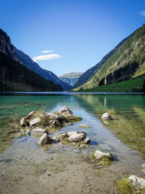 Scenic Mountain Lake Reflecting Clear Sky · Free Stock Photo