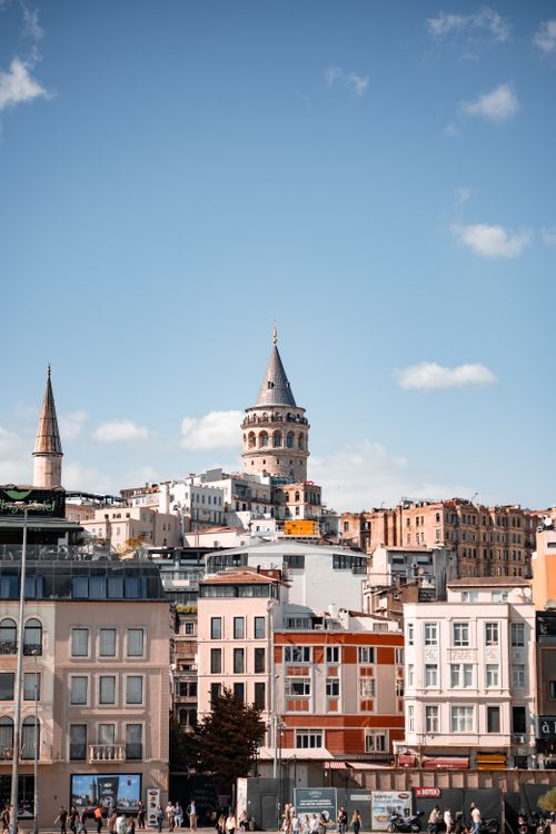 Free View of the Galata Tower amidst vibrant Istanbul architecture under a clear sky. Stock Photo