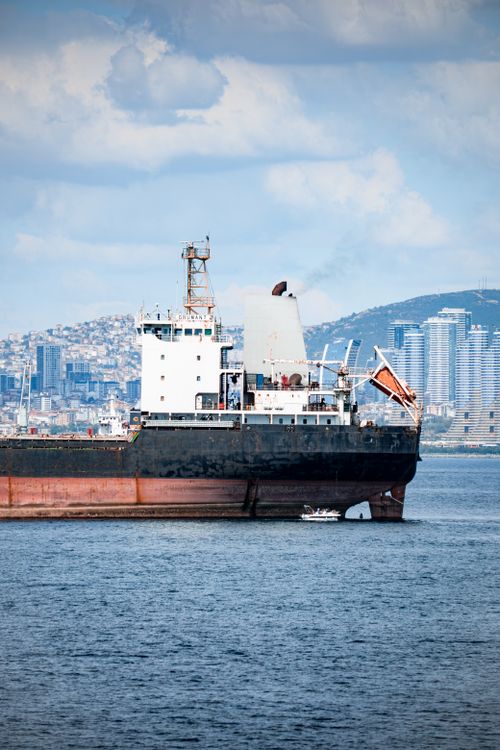 Free A cargo ship is docked in Istanbul Harbor, with the city's skyline providing a stunning backdrop. Stock Photo