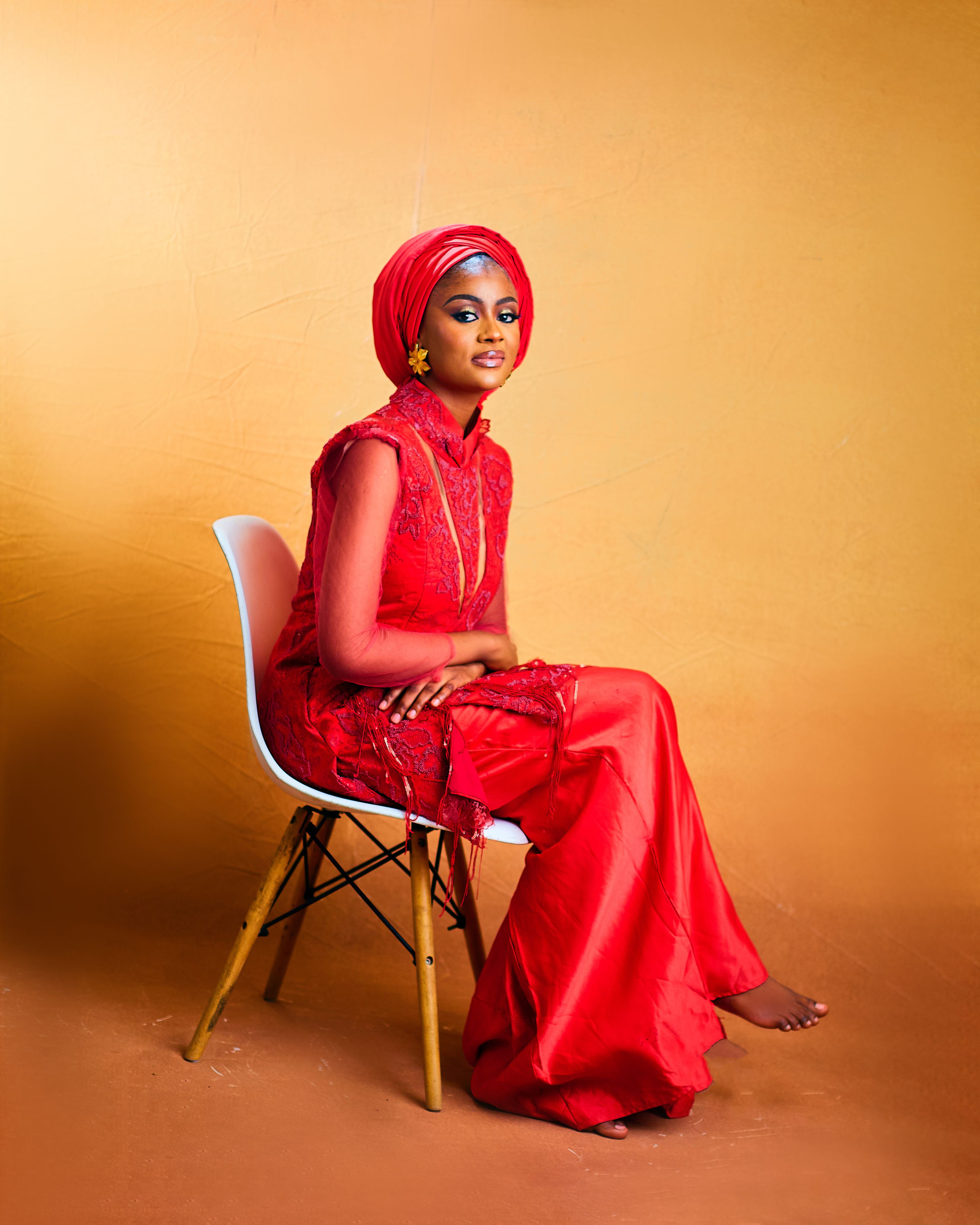 Elegant Woman in Traditional Red Dress Sitting on Chair · Free Stock Photo