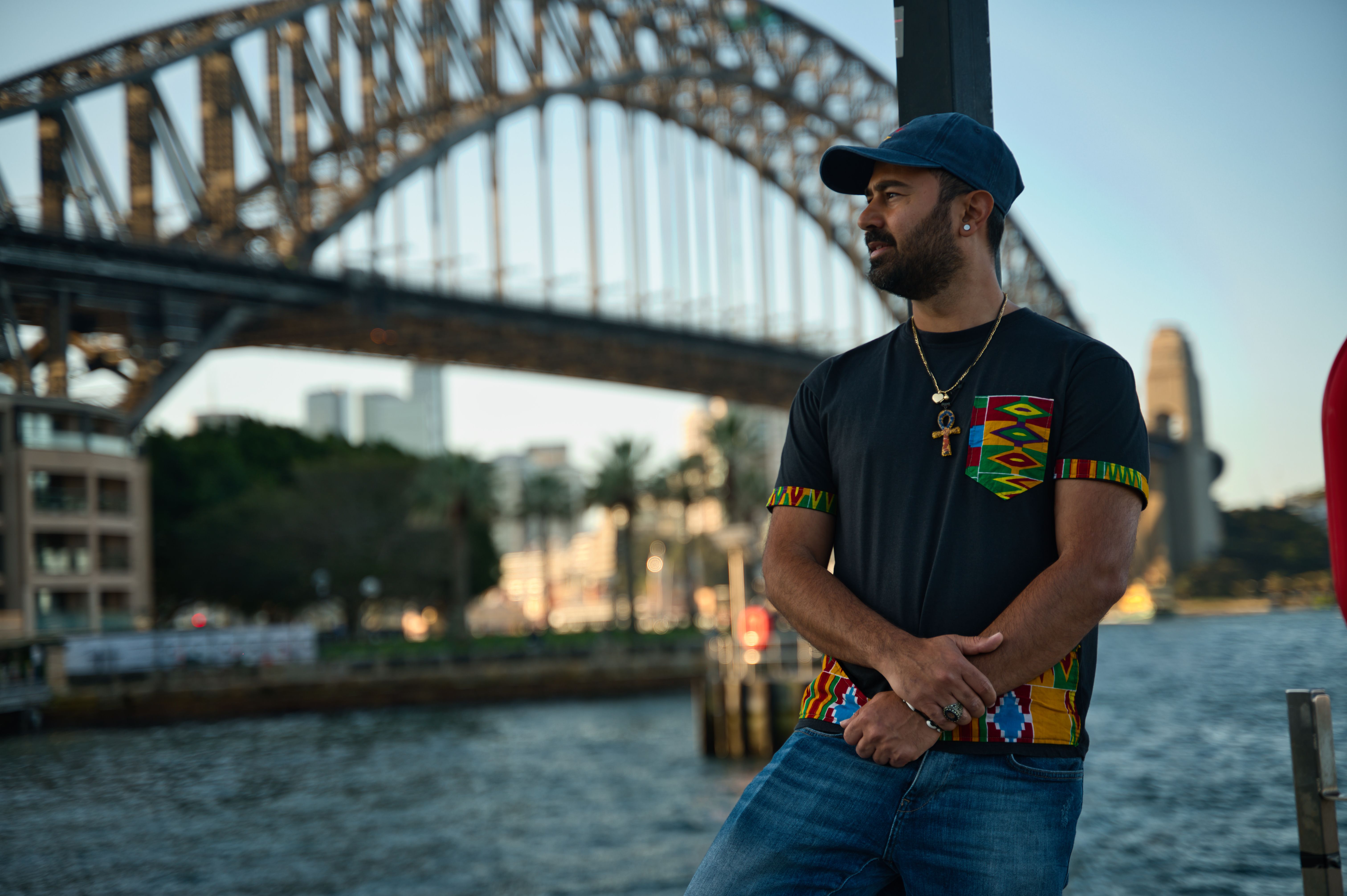 Stylish Man Posing by Sydney Harbour Bridge · Free Stock Photo