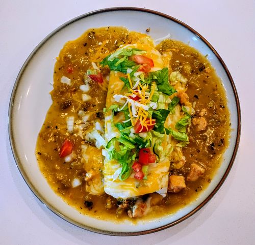 Free A Deliciously Colorful Smothered Green Chile Tex-Mex Burrito. Stock Photo