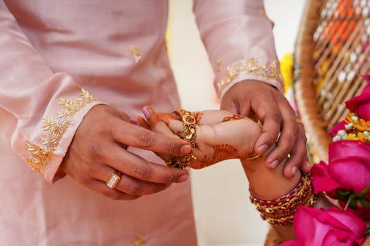 A close-up of a traditional Indian wedding ceremony with henna designs and jewelry.