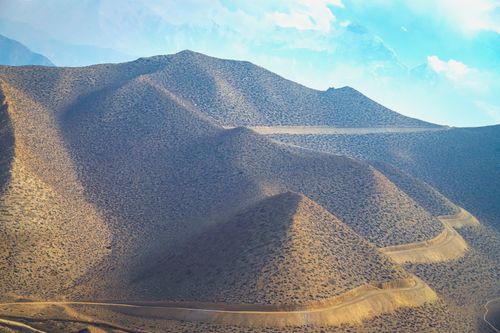 Free Beautiful view of rolling hills and winding paths in Upper Mustang, Nepal, showcasing a remote and rugged terrain. Stock Photo