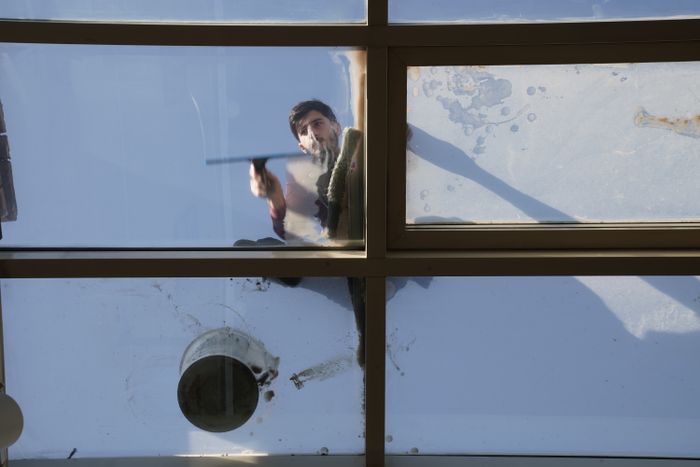 Window cleaning crew member working on a residential home