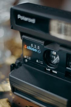 Detailed view of a vintage Polaroid 636 closeup camera lens highlighting nostalgia.