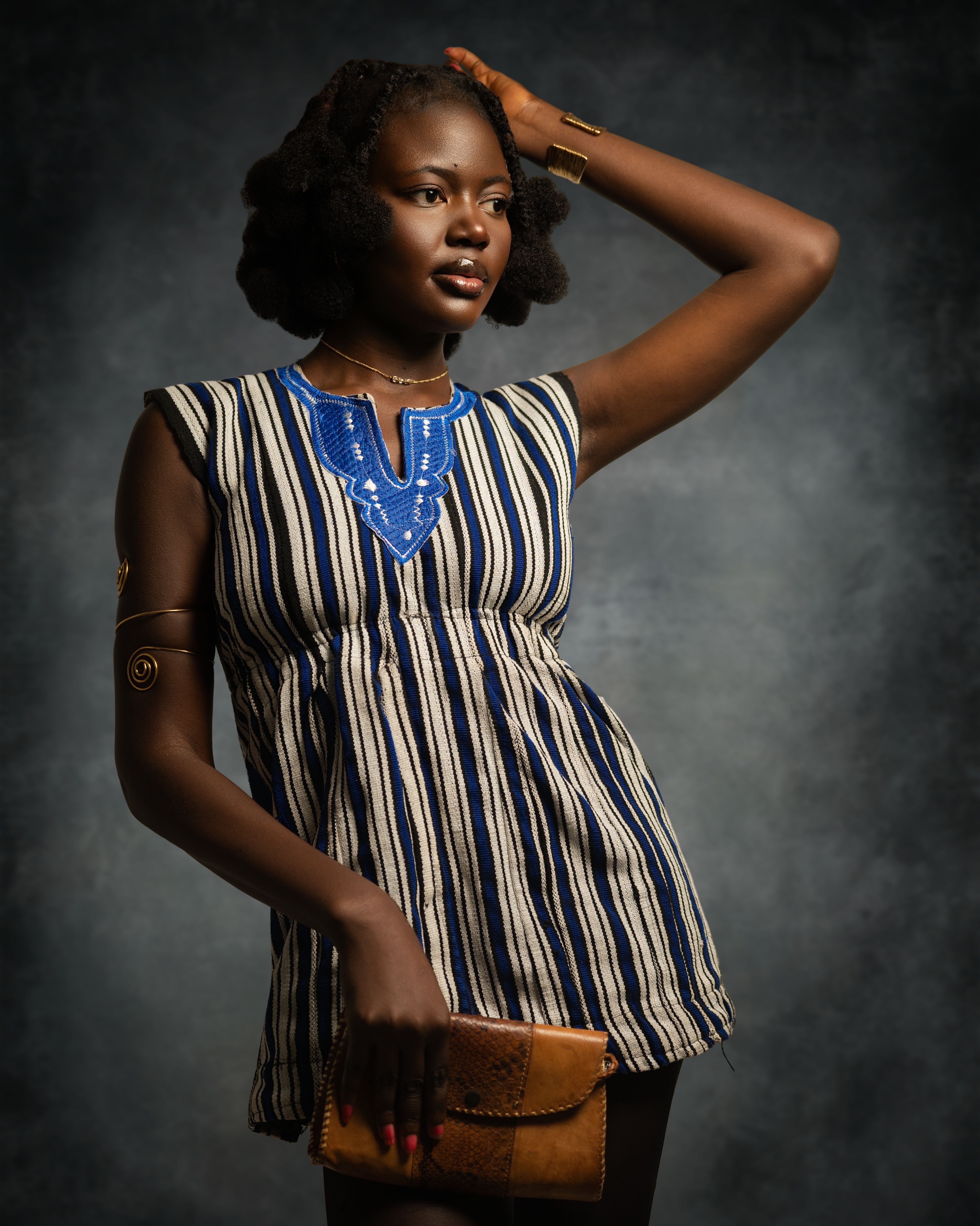 Stylish Woman in Traditional Striped Dress · Free Stock Photo