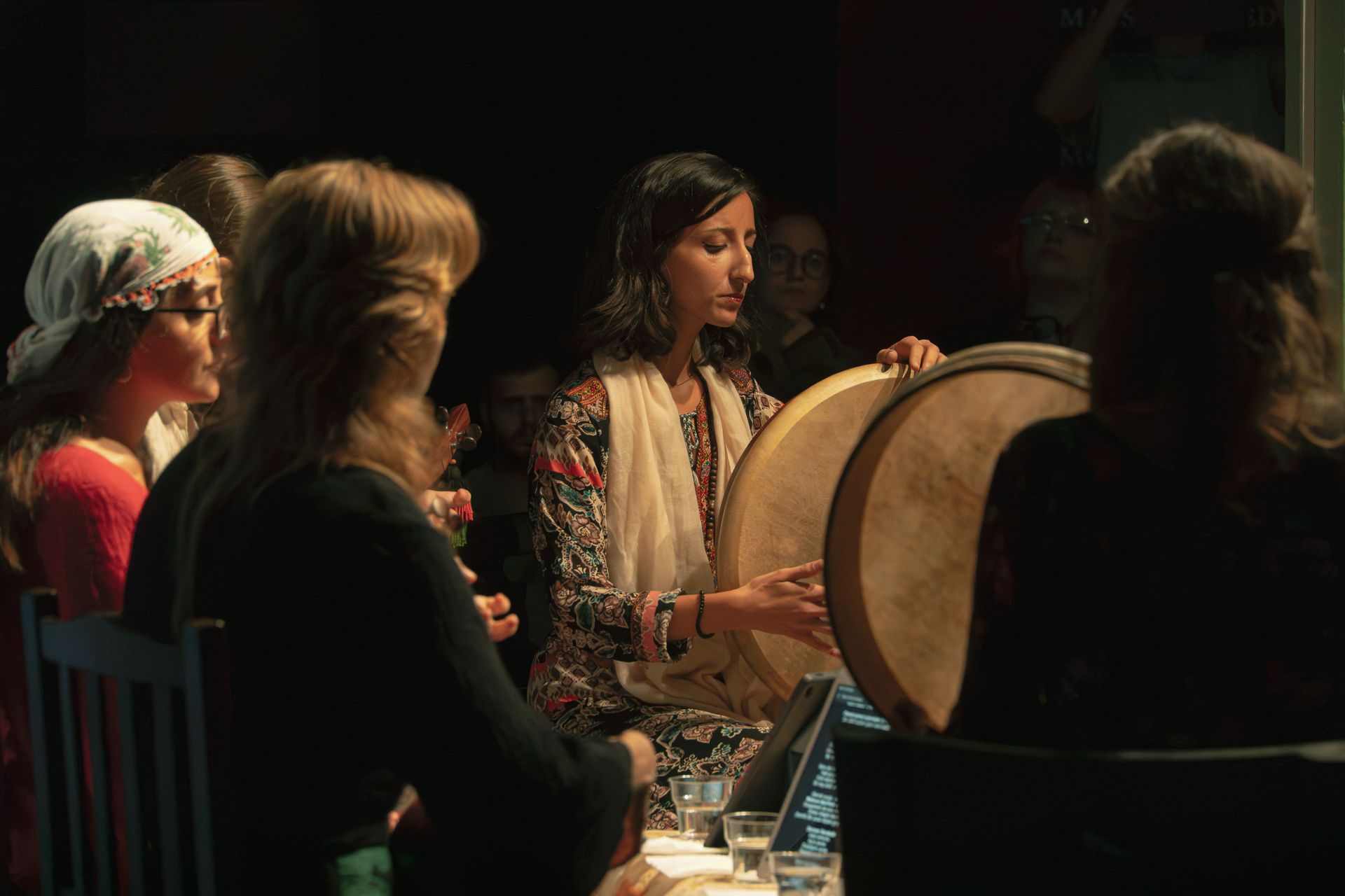 A group of musicians performing traditional music with drums at a cultural event in İstanbul.