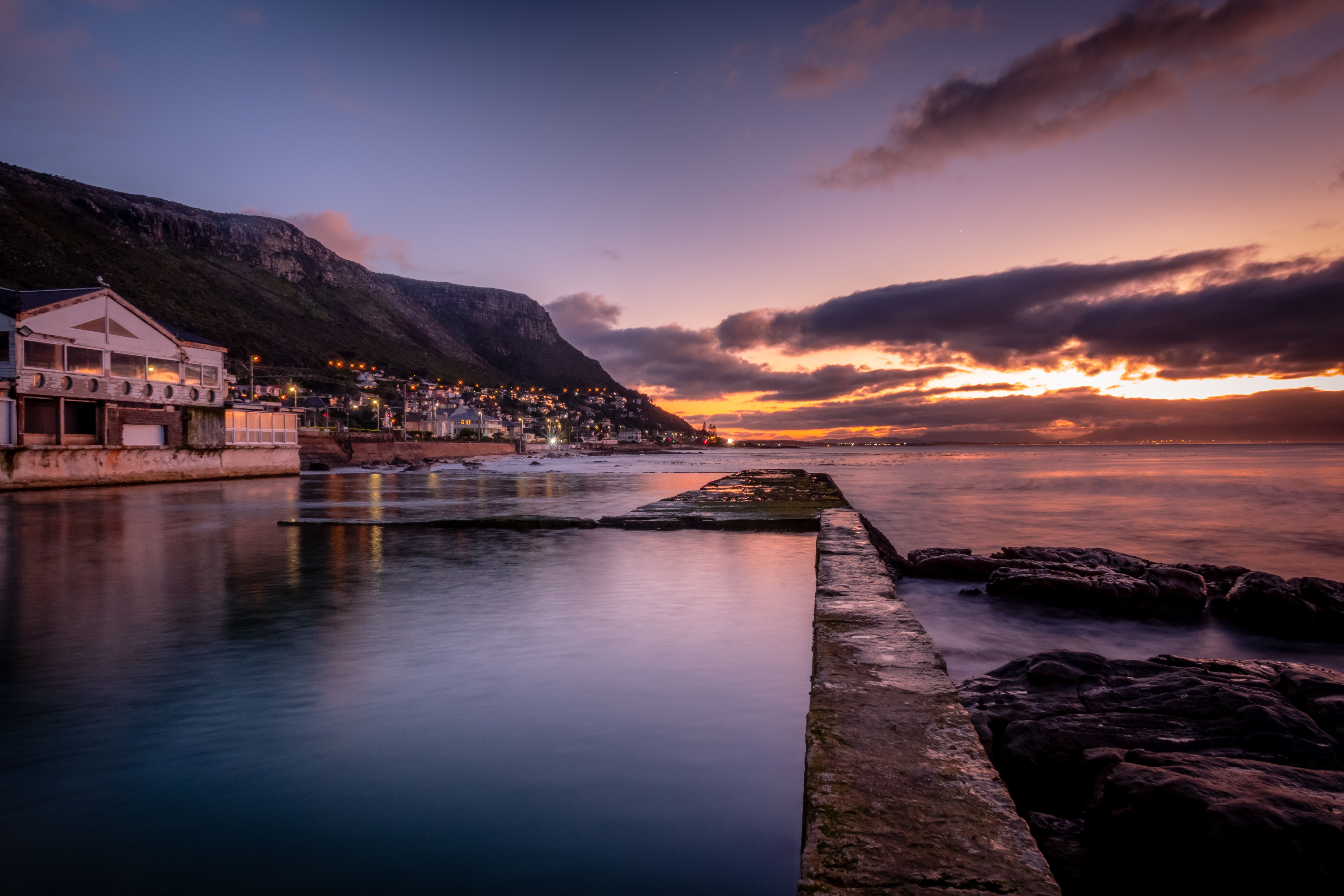 Scenic Coastal Sunset Over Mountainous Landscape · Free Stock Photo