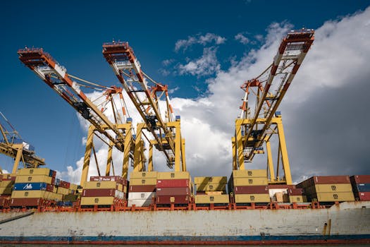 Dynamic view of container cranes operating at Bremerhaven port under a bright sky.