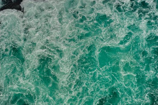 Aerial shot of swirling turquoise waters in Naruto, Tokushima, Japan, capturing nature's power.
