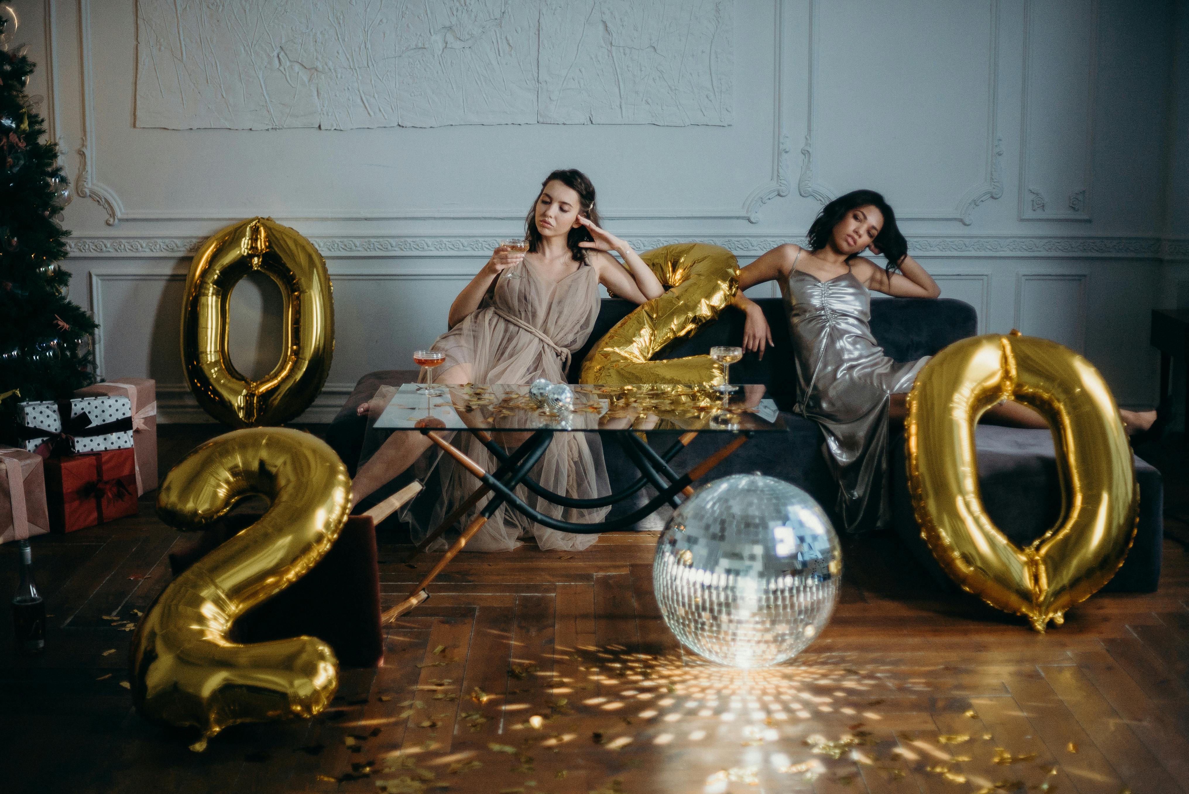 women sitting on sofa