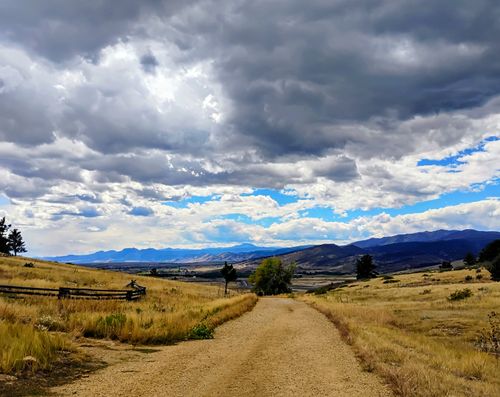 Free Where The Prairie Meets the Mountains. A Lonely Dirt To Road. Stock Photo