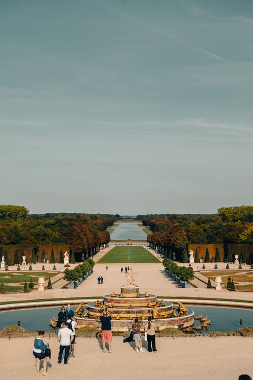 Free Stunning aerial view of the Versailles Palace Gardens during fall with visitors sightseeing. Stock Photo