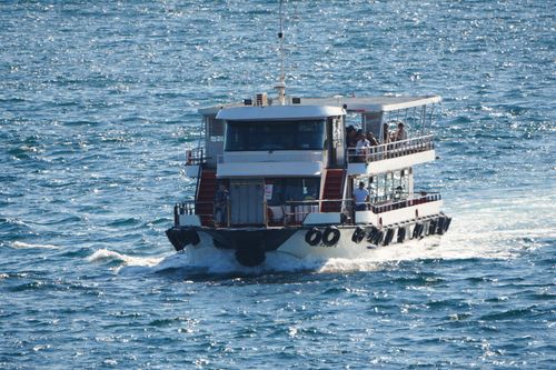 Free A passenger ferry traveling on the Bosphorus Strait in Istanbul, Türkiye, under clear skies. Stock Photo
