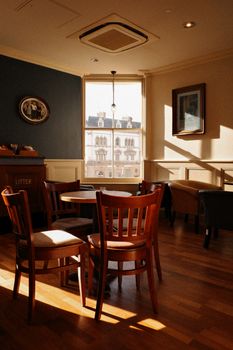Warm and inviting café interior with wooden furniture and natural light in Llandudno, Wales.