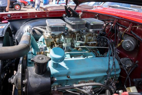 Free Close-up of a vintage car engine on display at a classic car show outdoors. Stock Photo