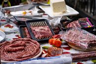 A variety of meats and vegetables arranged for an outdoor barbecue in Switzerland.