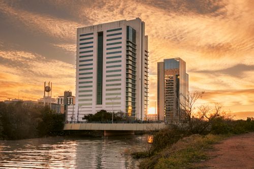 Free Stunning sunrise illuminates modern buildings in Porto Alegre, Brazil, creating a beautiful silhouette. Stock Photo