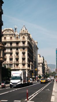 Vibrant streets of Barcelona captured on a sunny day, showcasing historic architecture.