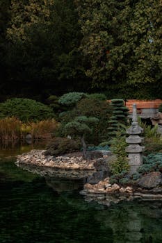 A tranquil Japanese garden in Wrocław with a pagoda sculpture by a pond.