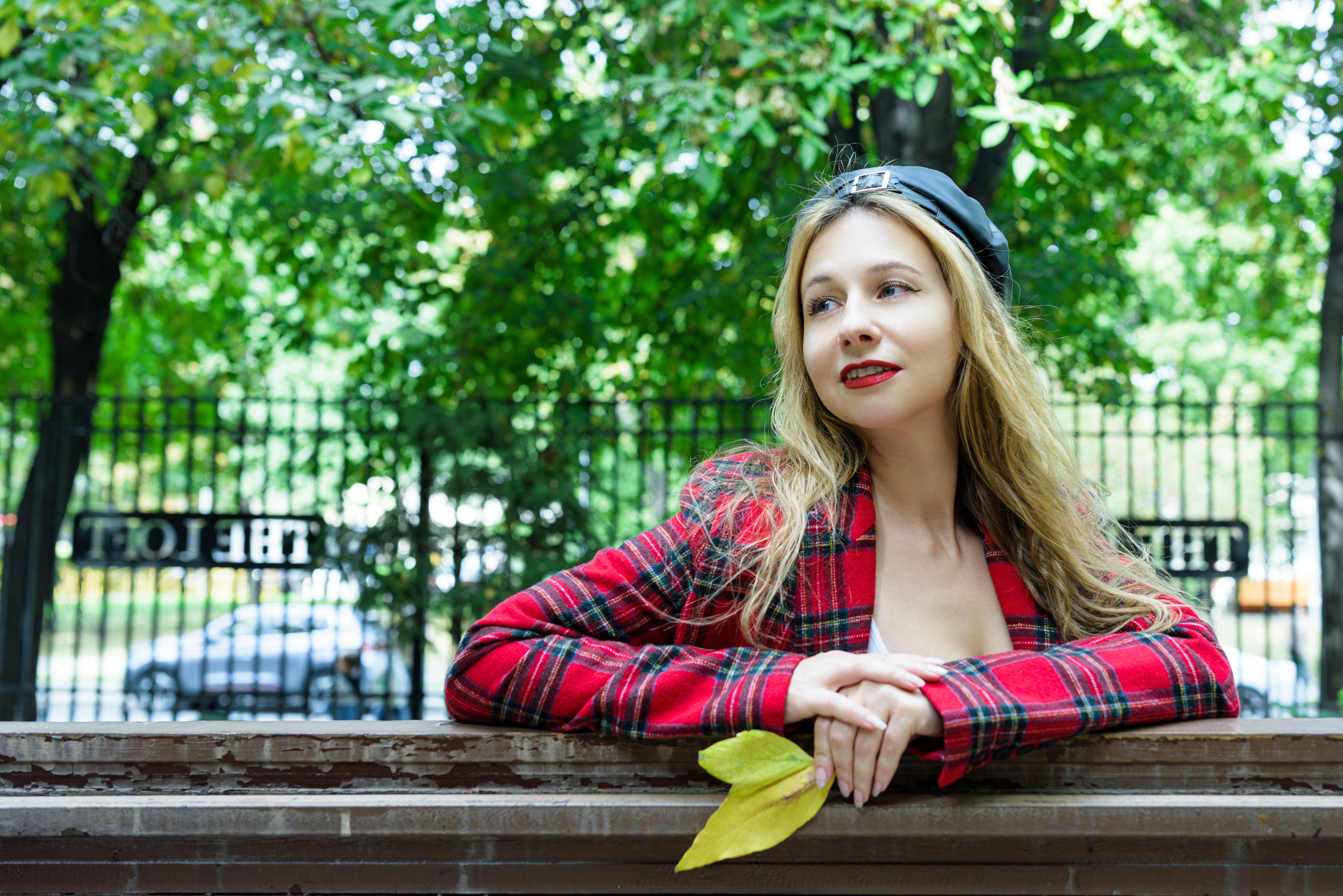 Young Woman Outdoors in Urban Park Setting · Free Stock Photo