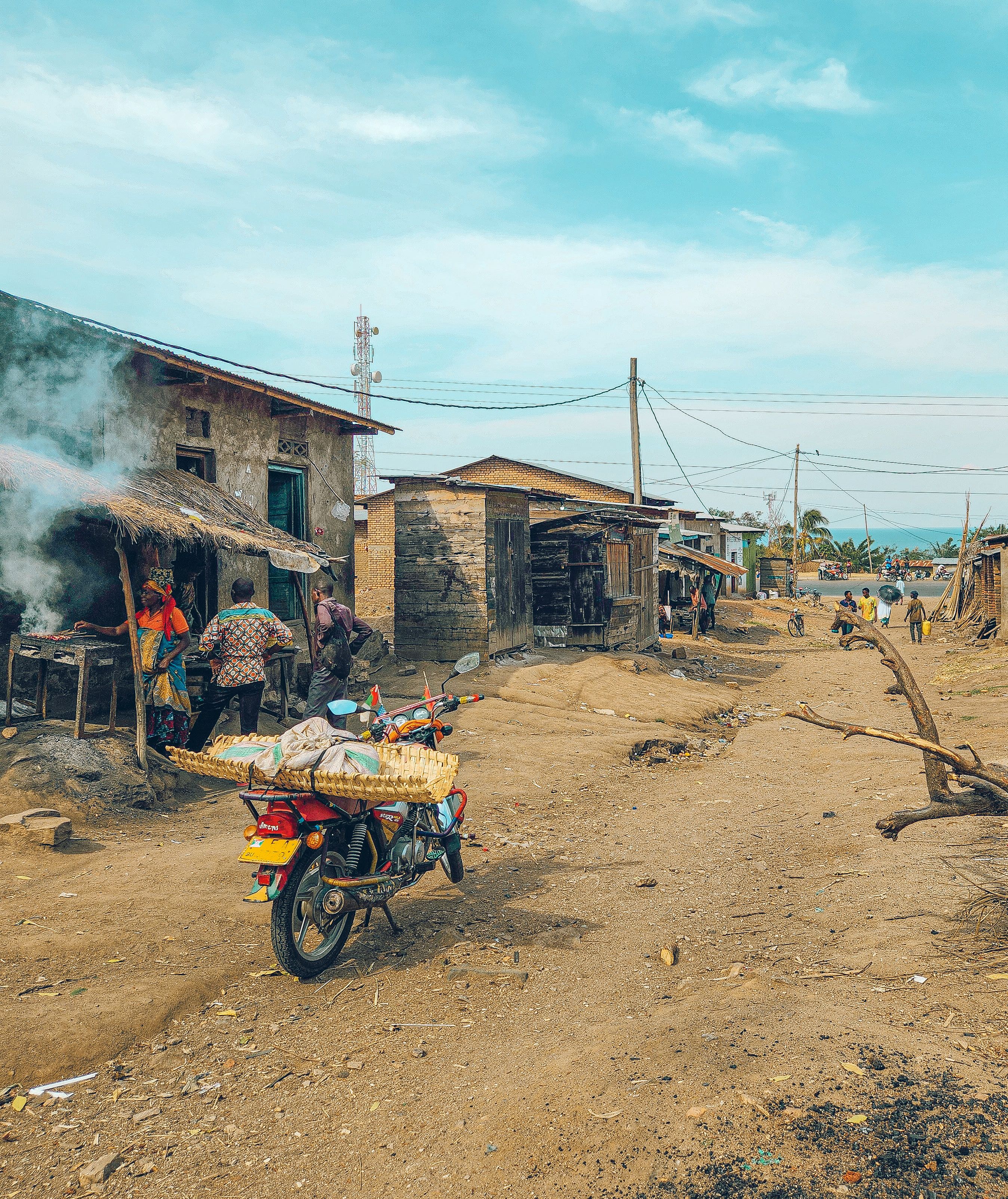 Rural African Village Street Scene with Motorcycle · Free Stock Photo