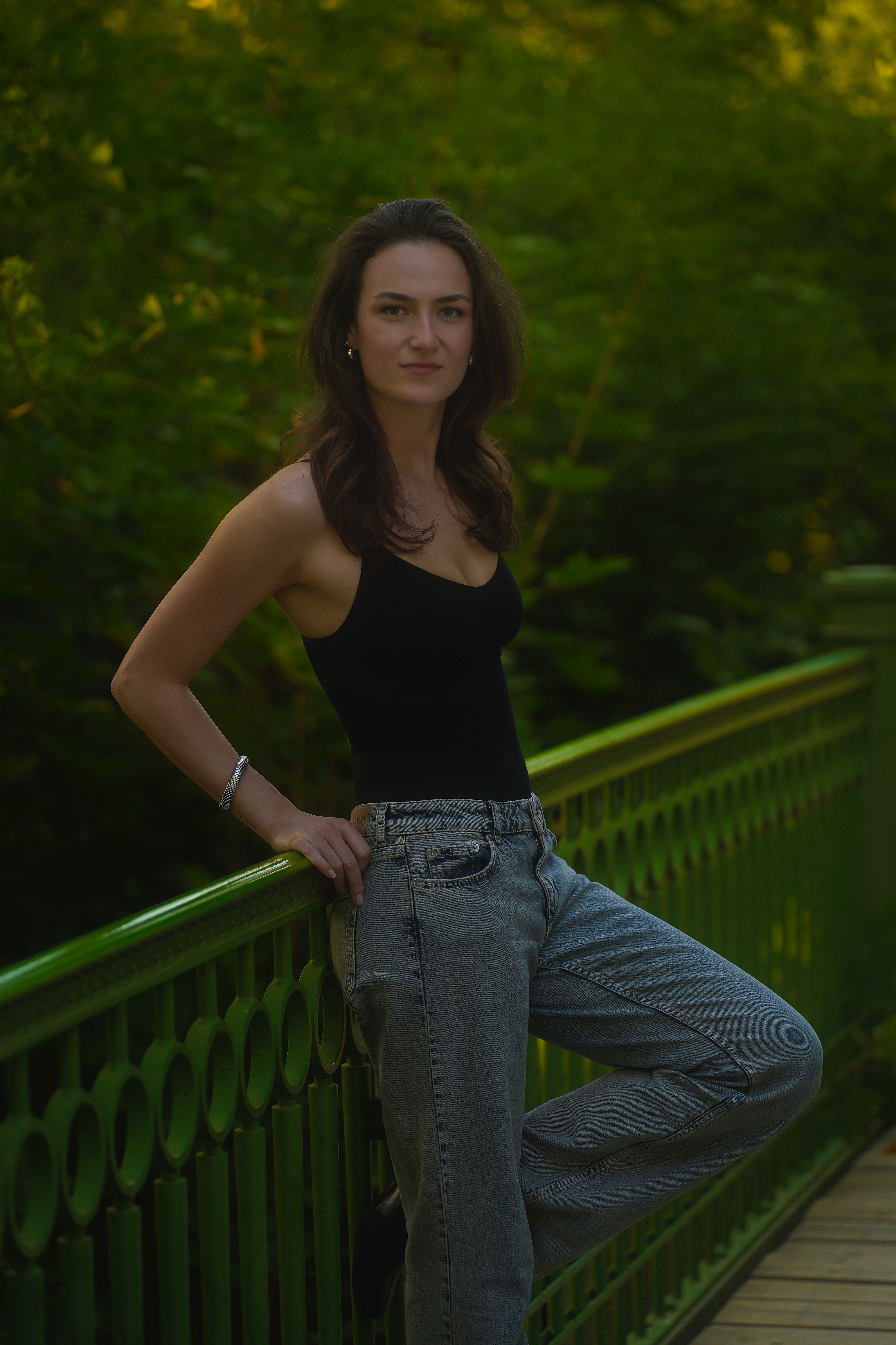 Woman Posing on a Green Bridge in Nature · Free Stock Photo