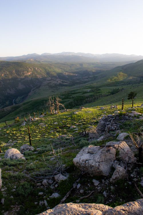 Free Stunning view of rolling hills and mountains during golden hour, showcasing natural beauty and tranquility. Stock Photo