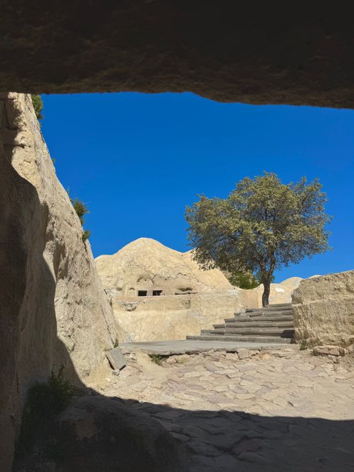 Free Explore the stunning rock formations and tree in Göreme, Nevşehir, Türkiye under a bright blue sky. Stock Photo