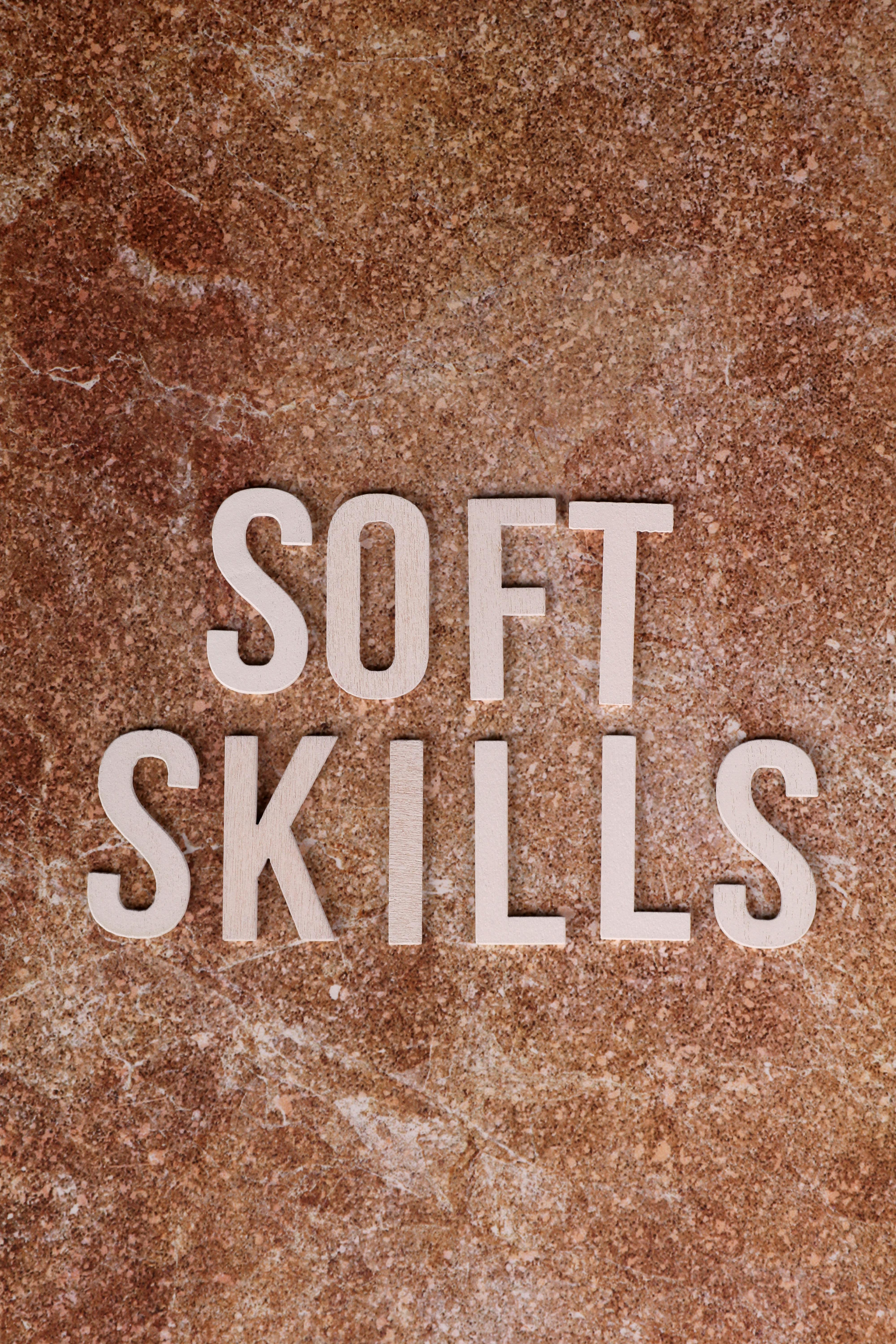 Image of 'Soft Skills' text on a textured stone background, emphasizing personal development.