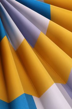 Close-up of colorful paper folds creating an abstract geometric pattern.