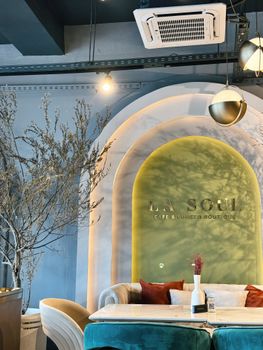 Stylish cafe interior featuring arched walls and elegant seating.
