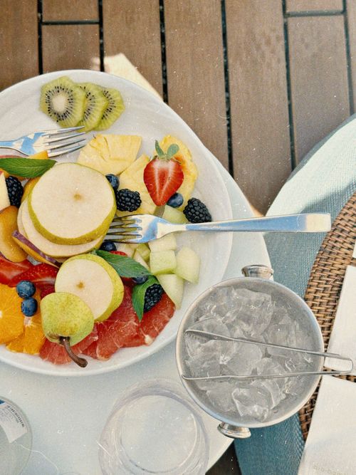 Free Colorful arranged fruit platter with ice bucket on a sunny outdoor table setting. Stock Photo